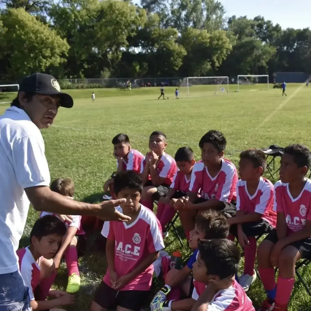 Coach giving team talk to young soccer players.